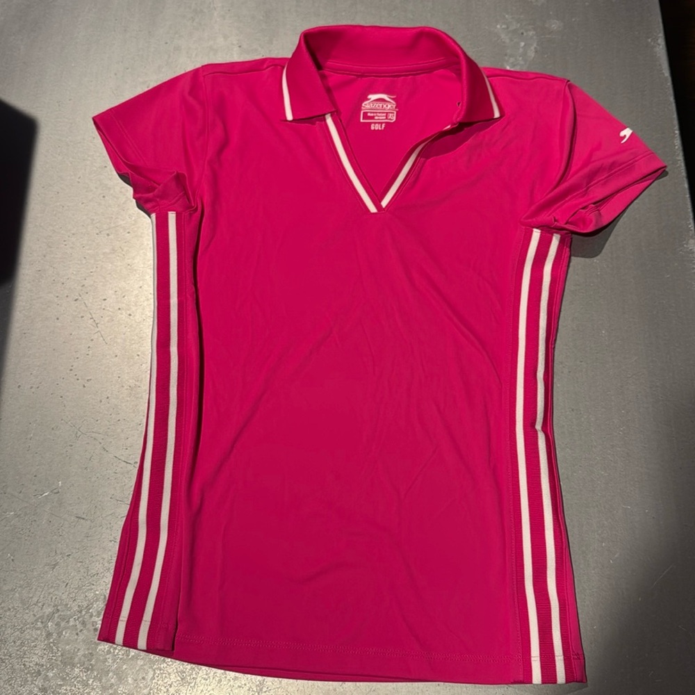Hot pink Women’s XS Slazenger golf shirt with white stripes down the sides.